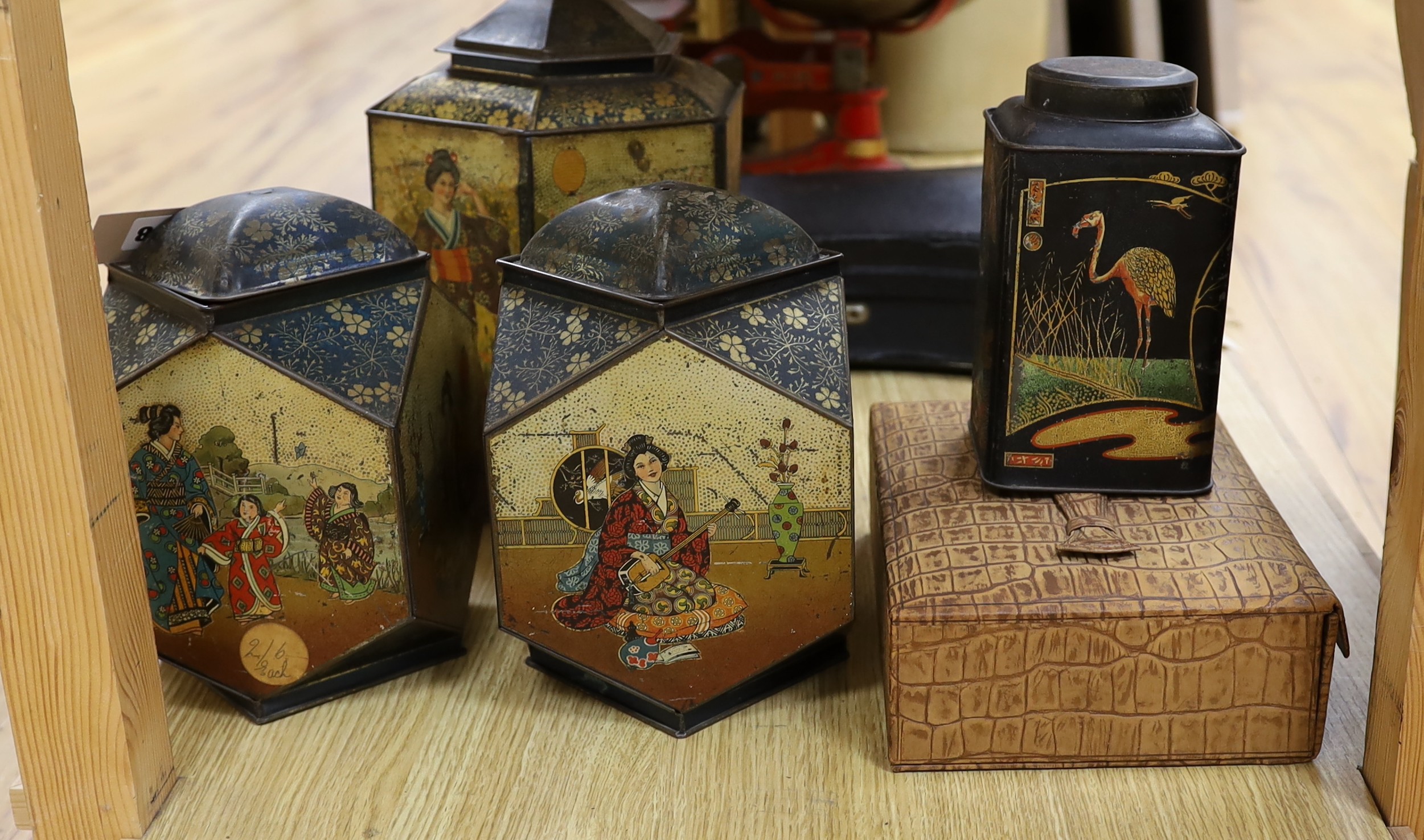 Four Japanned metal tea cannisters and a cased dressing set